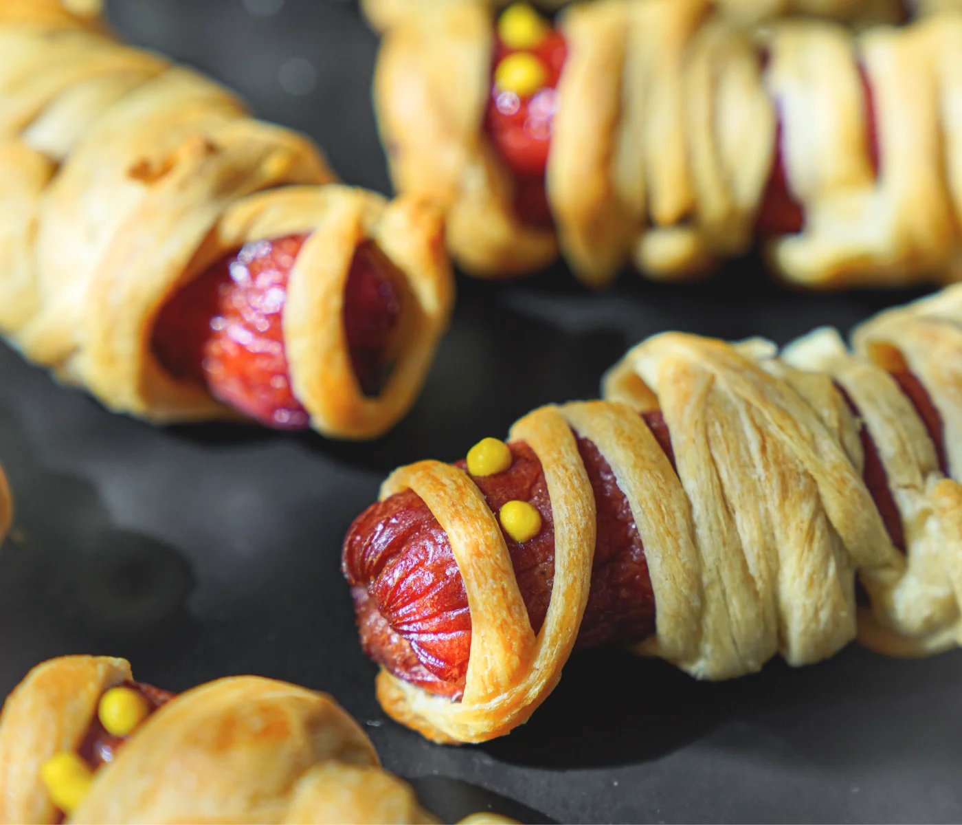 Crescent roll wrapped spookily around a hotdog, resembling a mummy.