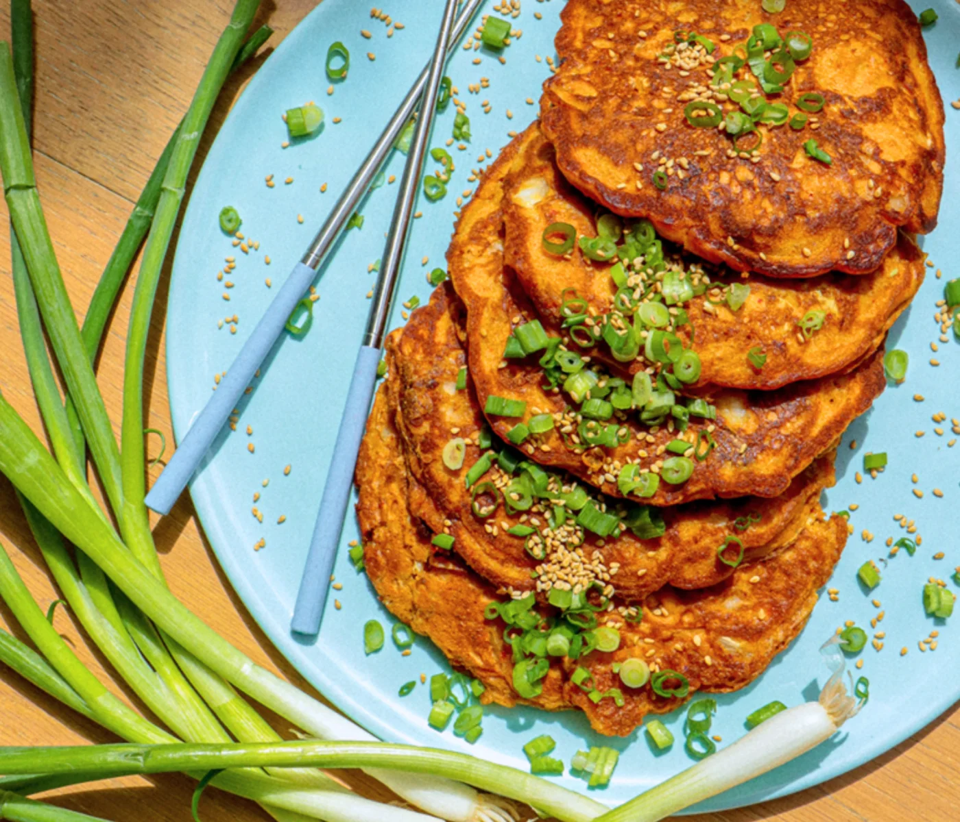 Savory golden kimchi pancakes, topped with green onions.