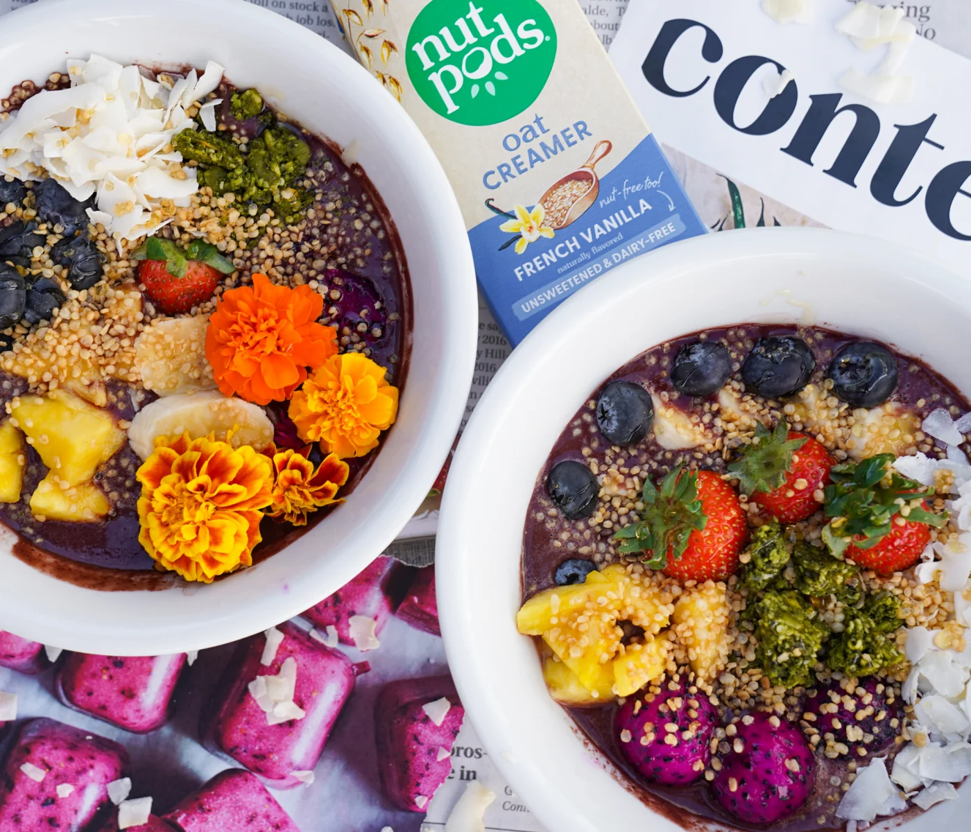 Vanilla apple acai bowl topped with edible flowers, fruit and coconut.